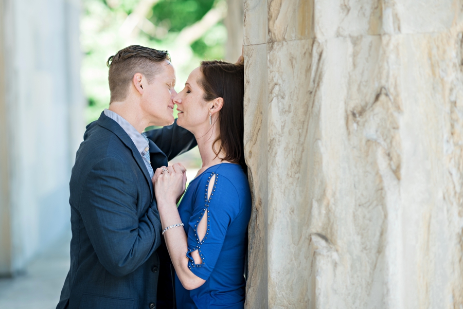 A man leans in to kiss his fiance at the second bank of america.